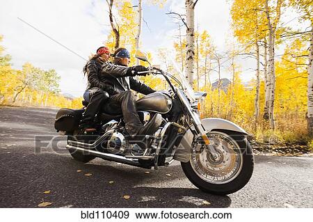 Caucasian couple riding motorcycle View Large Photo Image Stock Photo - Caucasian couple riding motorcycle. Fotosearch