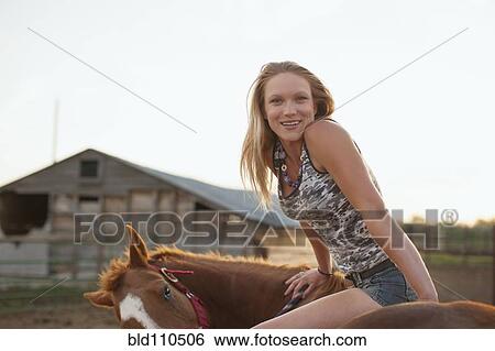Stock Photograph - Caucasian girl sitting on horse. Fotosearch