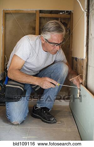 Caucasian man using screwdriver View Large Photo Image Stock Photograph - Caucasian man using screwdriver. Fotosearch