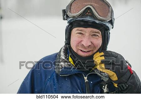Picture - Caucasian man wearing ski gear in snow. Fotosearch