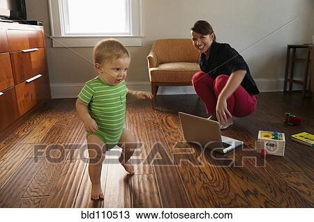 Caucasian mother watching toddler son walk View Large Photo Image Stock Image - Caucasian mother watching toddler son walk. Fotosearch