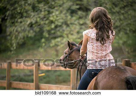 Caucasian woman riding horse in pen View Large Photo Image Stock Photo - Caucasian woman riding horse in pen. Fotosearch