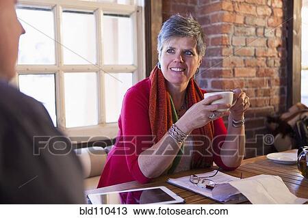 Caucasian woman talking in cafe View Large Photo Image Stock Image - Caucasian woman talking in cafe. Fotosearch