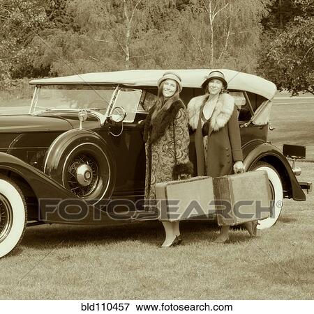 Caucasian women with luggage by vintage car View Large Photo Image Stock Photo - Caucasian women with luggage by vintage car. Fotosearch