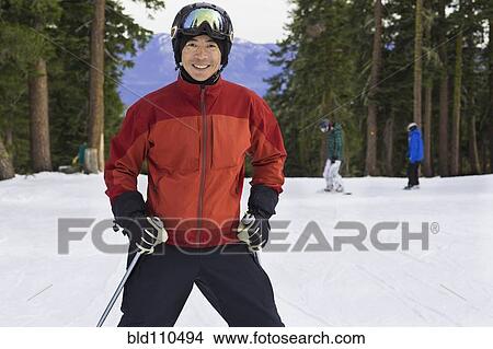 Picture - Chinese man wearing ski gear in snow. Fotosearch