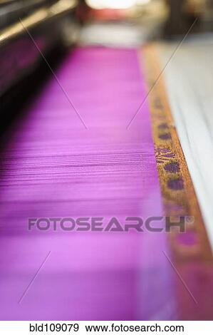 Stock Photo - Close up of fabric threads in loom. Fotosearch