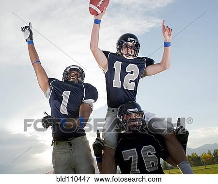 Stock Photo - Football players cheering in game. Fotosearch