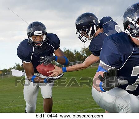 Football players passing ball View Large Photo Image Picture - Football players passing ball. Fotosearch
