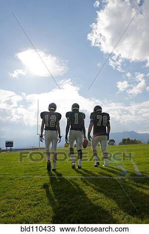 Football players walking on field View Large Photo Image Stock Image - Football players walking on field. Fotosearch