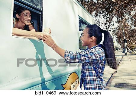 Stock Photo - Girl buying ice cream from truck. Fotosearch