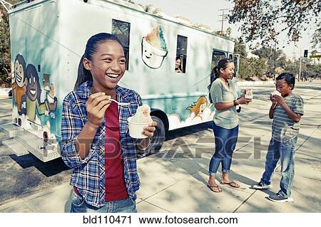 Girl eating ice cream from truck View Large Photo Image Stock Image - Girl eating ice cream from truck. Fotosearch