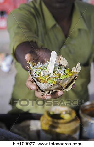 Stock Photo - Hand holding bowl of food. Fotosearch