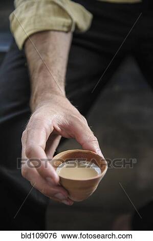 Hand holding cup of tea View Large Photo Image Stock Photograph - Hand holding cup of tea. Fotosearch