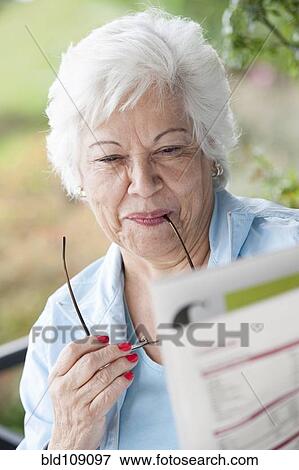 Hispanic woman reading newspaper View Large Photo Image Stock Photo - Hispanic woman reading newspaper. Fotosearch