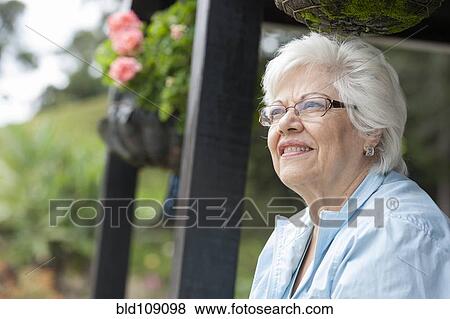 Stock Photo - Hispanic woman standing outdoors. Fotosearch