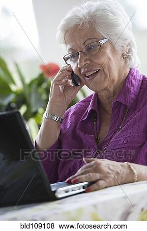 Hispanic woman using laptop View Large Photo Image Stock Photo - Hispanic woman using laptop. Fotosearch