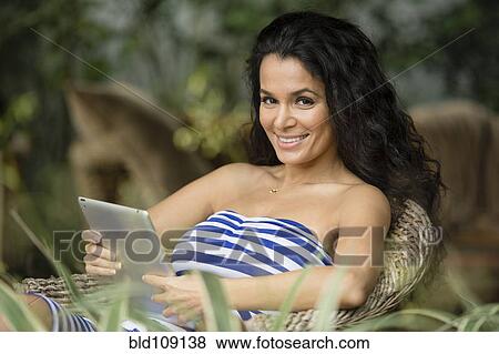 Hispanic woman using tablet computer View Large Photo Image Stock Photo - Hispanic woman using tablet computer. Fotosearch