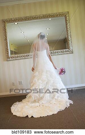 Stock Image - Lebanese bride admiring herself in mirror. Fotosearch