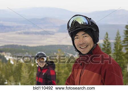 Stock Image - Men wearing ski gear in snow. Fotosearch