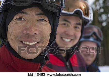 Stock Image - Men wearing ski gear in snow. Fotosearch