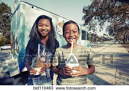 Mixed race children eating ice cream from truck View Large Photo Image Stock Image - Mixed race children eating ice cream from truck. Fotosearch