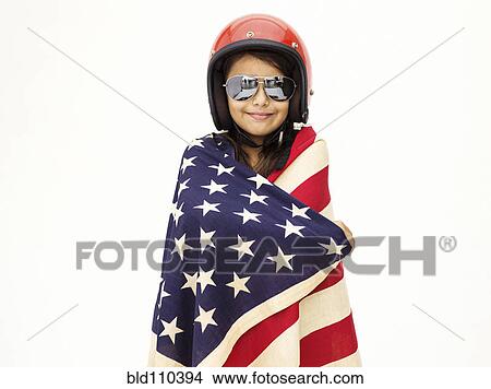 Picture - Mixed race girl wrapped in American flag. Fotosearch