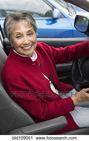 Stock Image - Mixed race woman driving in car. Fotosearch