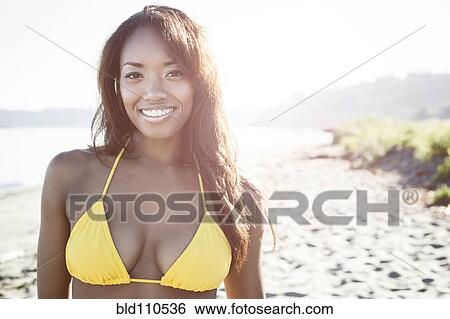 Stock Photograph - Mixed race woman in bikini on beach. Fotosearch