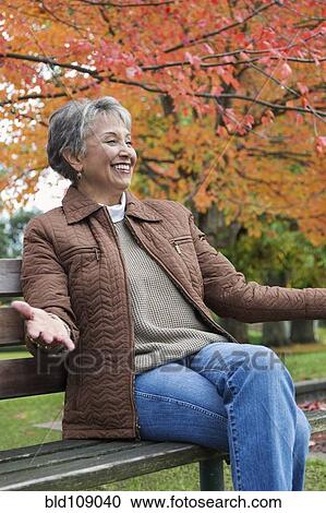 Mixed race woman on park bench View Large Photo Image Stock Image - Mixed race woman on park bench. Fotosearch
