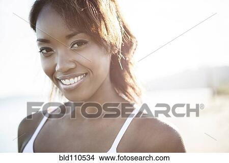 Picture - Mixed race woman smiling. Fotosearch