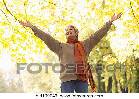 Stock Photo - Mixed race woman standing in park. Fotosearch