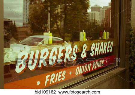 Stock Image - Sign reading? burgers & shakes? on restaurant windo. Fotosearch