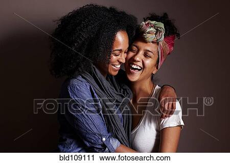Stock Image - Smiling women hugging. Fotosearch