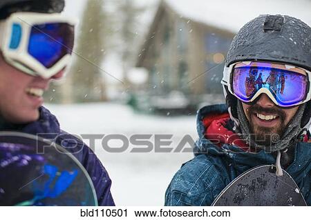 Snowboarders talking in snow View Large Photo Image Stock Image - Snowboarders talking in snow. Fotosearch