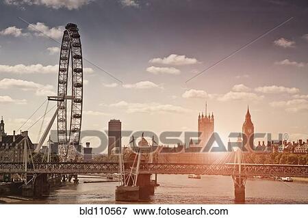 Stock Photo - Sunset over bridge and London Eye. Fotosearch