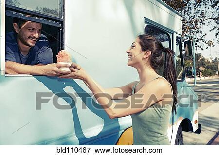 Stock Photo - Woman buying ice cream from truck. Fotosearch