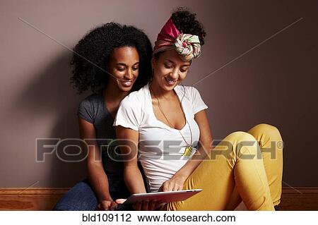 Women using tablet computer View Large Photo Image Stock Image - Women using tablet computer. Fotosearch