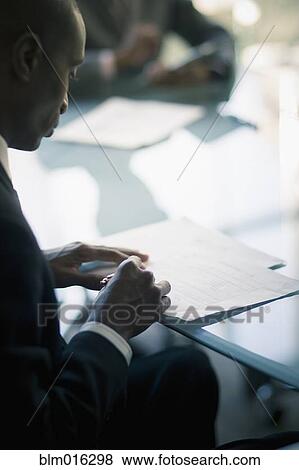 Black businessman reading notes View Large Photo Image Stock Photo - Black businessman reading notes. Fotosearch