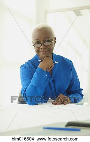 Picture - Black businesswoman at desk. Fotosearch