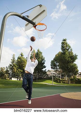 Stock Photo - Black man playing basketball. Fotosearch