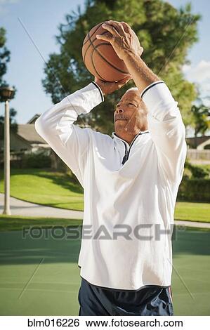 Stock Photograph - Black man playing basketball. Fotosearch