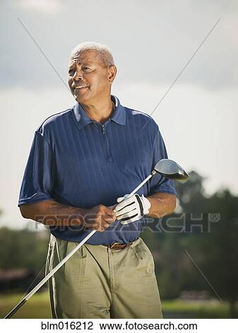 Stock Image - Black man playing golf. Fotosearch