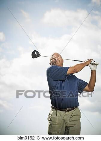 Stock Image - Black man playing golf. Fotosearch