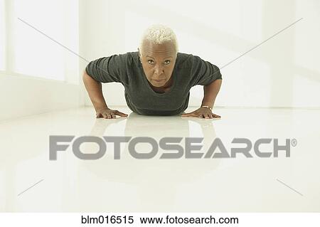 Stock Photography - Black woman doing push ups. Fotosearch