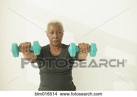 Picture - Black woman lifting weights. Fotosearch