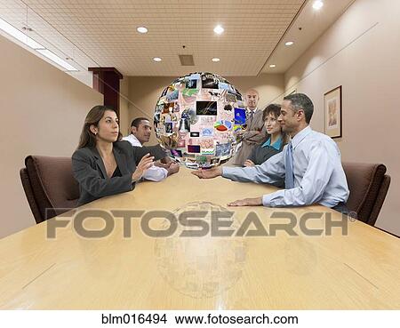 Picture - Business people admiring illustration of globe. Fotosearch
