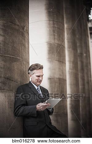 Stock Photo - Caucasian businessman using tablet computer. Fotosearch