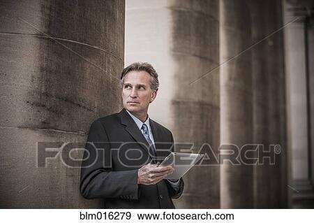 Stock Photo - Caucasian businessman using tablet computer. Fotosearch