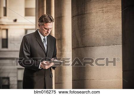 Caucasian businessman using tablet computer View Large Photo Image Stock Photography - Caucasian businessman using tablet computer. Fotosearch