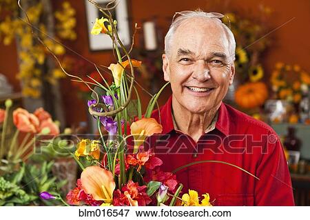Caucasian florist with bouquet in shop View Large Photo Image Stock Photo - Caucasian florist with bouquet in shop. Fotosearch